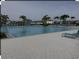 Inviting community pool with lounge chairs and a playground in the background at 7643 Ginger Lily Ct, Tampa, FL 33619