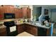 Modern kitchen featuring ample cabinetry, granite countertops, and stainless steel appliances at 7643 Ginger Lily Ct, Tampa, FL 33619