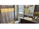 Bathroom with shower/tub combo, granite vanity, and neutral decor at 7643 Ginger Lily Ct, Tampa, FL 33619