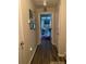 Bright hallway with wood-look floors leading to bedrooms at 7643 Ginger Lily Ct, Tampa, FL 33619