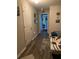 Long hallway with light wood flooring and access to bedrooms at 7643 Ginger Lily Ct, Tampa, FL 33619