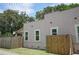 Rear view of Spanish style home with stucco exterior and wooden fence at 1817 20Th S Ave, St Petersburg, FL 33712