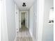 Long hallway with light gray walls and wood-look floors at 1817 20Th S Ave, St Petersburg, FL 33712