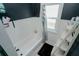 Bathroom with bathtub, window, and white ladder shelf at 1817 20Th S Ave, St Petersburg, FL 33712