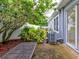 Small, private backyard with patio furniture and lush greenery at 2745 Enterprise E Rd # 24, Clearwater, FL 33759