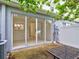 Glass sliding doors open to a small back patio and table at 2745 Enterprise E Rd # 24, Clearwater, FL 33759