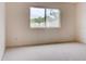 Simple bedroom with a window and carpet at 2745 Enterprise E Rd # 24, Clearwater, FL 33759