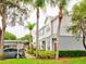 Townhome with gray siding, red door, and lush landscaping at 2745 Enterprise E Rd # 24, Clearwater, FL 33759
