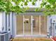 Glass sliding doors open to a cozy back patio with table at 2745 Enterprise E Rd # 24, Clearwater, FL 33759
