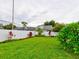 Landscaped backyard with lush greenery and privacy wall at 2745 Enterprise E Rd # 24, Clearwater, FL 33759
