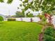 Landscaped backyard with lush greenery and privacy wall at 2745 Enterprise E Rd # 24, Clearwater, FL 33759