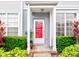 Townhouse entrance with red door and landscaping at 2745 Enterprise E Rd # 24, Clearwater, FL 33759