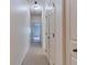 Hallway with carpet flooring and doors to bedrooms and closets at 2745 Enterprise E Rd # 24, Clearwater, FL 33759