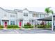 Two-story townhome with gray siding, red doors, and covered parking at 2745 Enterprise E Rd # 24, Clearwater, FL 33759