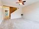 Two-story living room with stairs and ceiling fan at 2745 Enterprise E Rd # 24, Clearwater, FL 33759