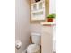 Simple bathroom with a toilet and a wall-mounted cabinet at 2745 Enterprise E Rd # 24, Clearwater, FL 33759