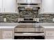 Stainless steel range and contemporary backsplash in kitchen at 2745 Enterprise E Rd # 24, Clearwater, FL 33759
