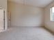 Empty bedroom with window and carpet at 2745 Enterprise E Rd # 24, Clearwater, FL 33759
