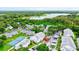 Aerial view showcasing condo location, tennis court, and lake views at 2745 Enterprise E Rd # 24, Clearwater, FL 33759