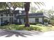 House exterior with manicured lawn and landscaping at 1211 N Mcmullen Booth Rd # 1211, Clearwater, FL 33759