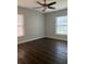Spacious bedroom with wood-look flooring and ceiling fan at 1211 N Mcmullen Booth Rd # 1211, Clearwater, FL 33759