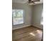 Bright bedroom with wood-look flooring and large window at 1211 N Mcmullen Booth Rd # 1211, Clearwater, FL 33759
