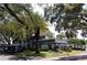 Building exterior surrounded by lush landscaping and palm trees at 1211 N Mcmullen Booth Rd # 1211, Clearwater, FL 33759
