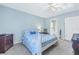 Comfortable bedroom featuring a bed with sea life bedding, a ceiling fan and blue walls at 4115 34Th S Way # 195, St Petersburg, FL 33711