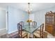 Dining room with glass table, chandelier, and hardwood floors at 4115 34Th S Way # 195, St Petersburg, FL 33711