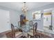Dining room with glass table, chandelier, and hardwood floors at 4115 34Th S Way # 195, St Petersburg, FL 33711