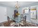 Dining area with a glass table, chandelier, and convenient kitchen access at 4115 34Th S Way # 195, St Petersburg, FL 33711