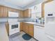 Kitchen with wood cabinets and white appliances at 4115 34Th S Way # 195, St Petersburg, FL 33711