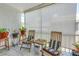 The sunroom has bright light, tiled floors, plants, and chairs at 4115 34Th S Way # 195, St Petersburg, FL 33711
