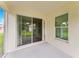 Screened patio with sliding glass doors and backyard view at 4986 Ariton Rd, North Port, FL 34288