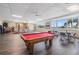 Community room features a pool table, tables, and chairs, along with water views at 100 Bluff View Dr # 604A, Belleair Bluffs, FL 33770