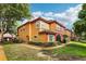 Charming two-story condo with a red tiled roof, complemented by lush landscaping and colorful accents at 2272 Chianti Pl # 4-0048, Palm Harbor, FL 34683