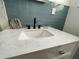 Modern bathroom sink with quartz countertop and blue tile backsplash at 224 6Th N Ave # 12, St Petersburg, FL 33701
