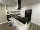 Modern kitchen with white cabinets, granite counters, and stainless steel appliances at 224 6Th N Ave # 12, St Petersburg, FL 33701