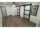 Bright bedroom with wood-look floors and barn doors at 224 6Th N Ave # 12, St Petersburg, FL 33701