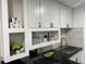 White shaker cabinets, mosaic backsplash, and granite countertops at 224 6Th N Ave # 12, St Petersburg, FL 33701