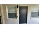 Private condo entrance with a modern dark-grey door and windows at 224 6Th N Ave # 12, St Petersburg, FL 33701