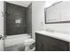 Modern bathroom with dark gray tile and white vanity at 2272 Chianti Pl # 4-0048, Palm Harbor, FL 34683