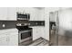 Modern kitchen with stainless steel appliances and white cabinets at 2272 Chianti Pl # 4-0048, Palm Harbor, FL 34683