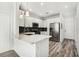 Modern kitchen with white cabinets, stainless steel appliances, and quartz countertops at 2272 Chianti Pl # 4-0048, Palm Harbor, FL 34683