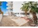 Ground level patio area with seating and ocean views at 19610 Gulf Blvd # 308, Indian Shores, FL 33785