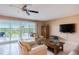 Living room with comfy seating, large TV, and balcony access at 19610 Gulf Blvd # 308, Indian Shores, FL 33785