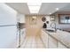 White kitchen with granite countertops and stainless steel appliances at 19610 Gulf Blvd # 308, Indian Shores, FL 33785