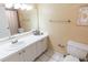 Bathroom with white vanity, tiled shower, and toilet at 19610 Gulf Blvd # 308, Indian Shores, FL 33785