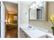 Bathroom with single sink and view into bedroom at 19610 Gulf Blvd # 308, Indian Shores, FL 33785