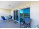 Relaxing balcony with outdoor seating and sliding door access at 19610 Gulf Blvd # 308, Indian Shores, FL 33785